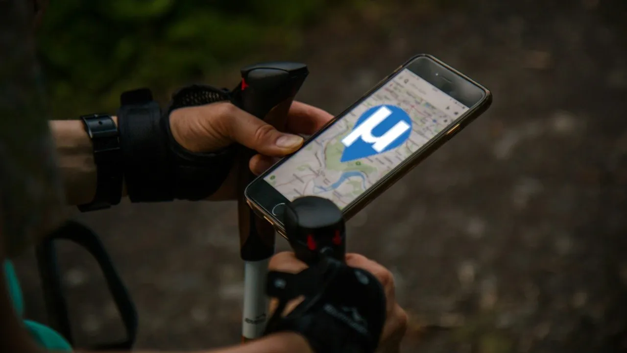 一個人在徒步旅行時查看數位地圖的照片。
