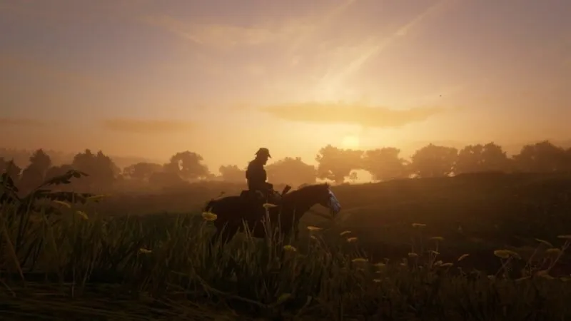 Screenshot van Red Dead Redemption 2 toont een man die op een paard rijdt terwijl hij baadt in het zonlicht