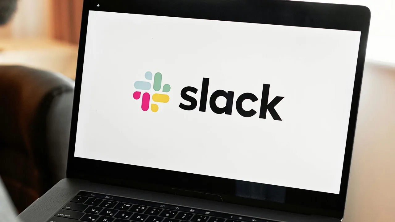 The Slack logo on a person's laptop