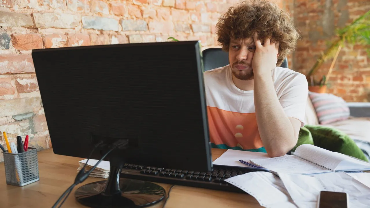 man using PC looking upset