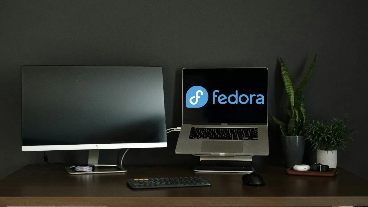 A laptop alongside a monitor set on a table.