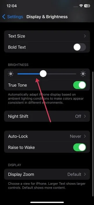 Adjusting brightness settings on iPhone.