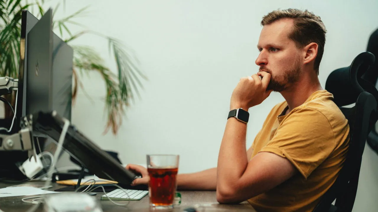 An image featuring an individual working on a desktop computer.